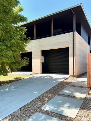 a building with a garage with a driveway at Riverbank House in Mudgee