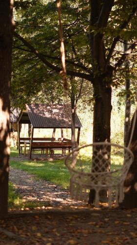 a park bench in a park with a gazebo at Гранд Алексік in Truskavets