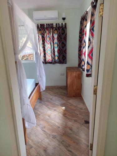 a small room with a bed and a window at Princess of Zanzibar in Michamvi