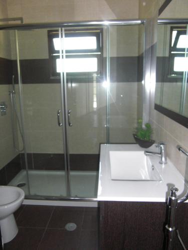 a bathroom with a shower and a sink and a toilet at Casa Marciana in Geres