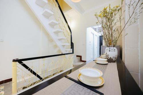 a dining room with two plates on a table at Flower Homestay - 50m to Old Quarter - Cosy home - 3Brs - FreeBreakfast in Hanoi