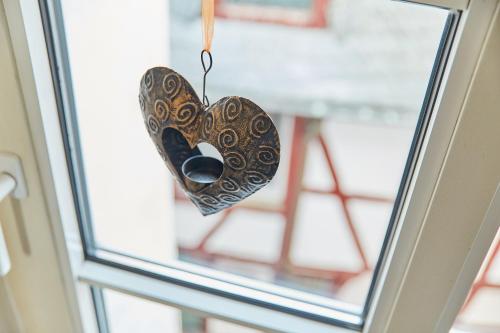 a heart shaped butterfly hanging from a window at Fachwerkperle am historischen Marktplatz in Bernkastel-Kues