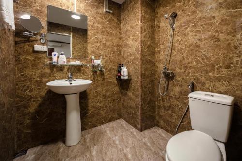 a bathroom with a toilet and a sink and a shower at A25 Hotel - 80 Mai Hắc Đế in Hanoi