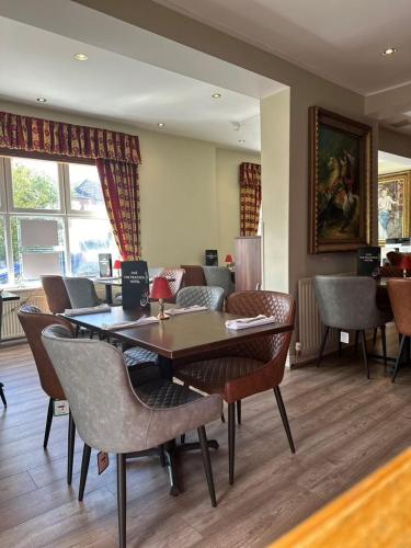 a dining room with a table and chairs at The Peacock Townhouse Hotel Kenilworth - Warwick in Kenilworth