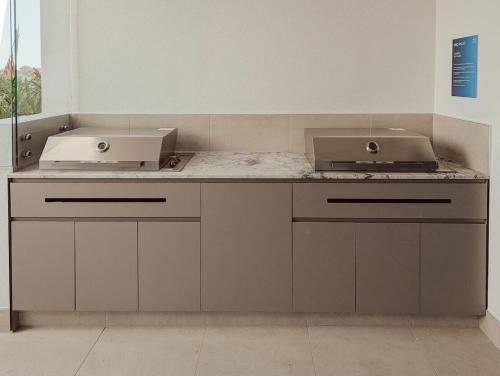 a kitchen with two sinks and a counter top at Azzure Escape in Kawana Waters