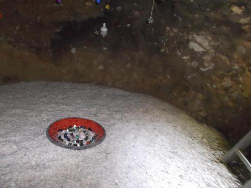 a red bowl filled with white pills in the snow at Ecoaldea Vegetariana y Vegana Espiral in Cabeceiras de Basto