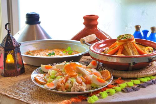 a table with two plates of food and a bowl of soup at Hoshinosora in Shodoshima