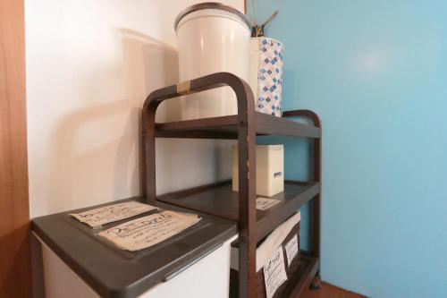 a shelf in a room with some boxes on it at Hoshinosora in Shodoshima
