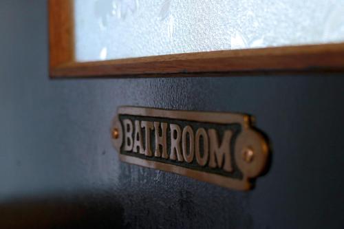 a sign on a door with the word bathroom on it at Hoshinosora in Shodoshima