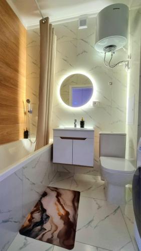 a white bathroom with a sink and a toilet at Янко 79 in Kokshetau