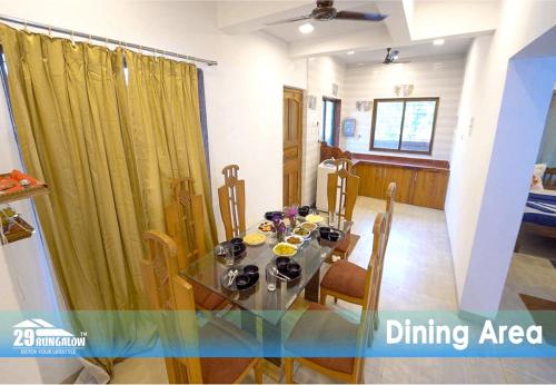 a dining area with a glass table and a dining room at Rooms at sea dreamz in Alibag