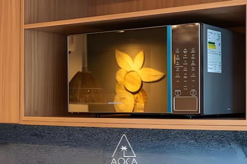 a microwave with a stuffed animal inside of it at Villa Naluri - Seu Refúgio a 50 metros da praia em Japaratinga in Japaratinga
