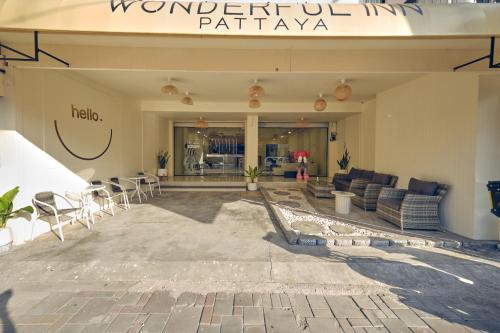a lobby of a building with chairs and tables at Wonderful inn 2 in Pattaya Central