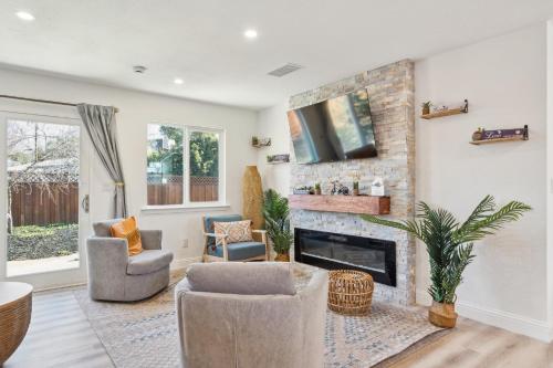 a living room with a fireplace and a tv at Cozy Home with Hot Tub - Family-Friendly Yard home in Livermore