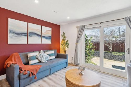 a living room with a blue couch and a window at Cozy Home with Hot Tub - Family-Friendly Yard home in Livermore
