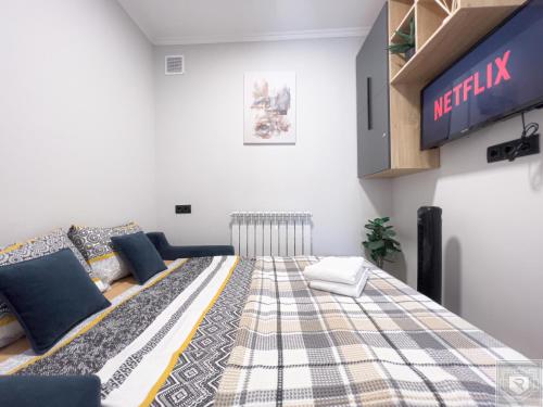 Habitación con cama y TV. en RentHouse Apartments Sleep&Go #3, en Chişinău