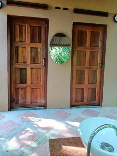 a pair of doors on a house with a window at Cliffside Lagoon Villa in Ao Nang Beach