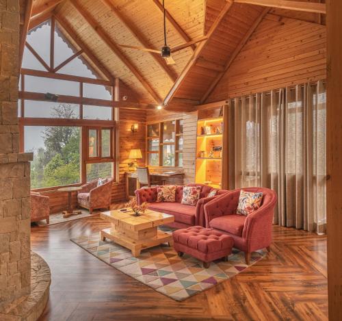 a living room with two couches and a table at Echor Mandara TreeVilla Dharamshala in Dharamshala