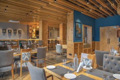 a dining room with a table and chairs at Echor Mandara TreeVilla Dharamshala in Dharamshala