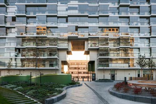 a large apartment building with balconies and a courtyard at Modern 1BR with Huge Balcony Above Mall of Tripla in Helsinki