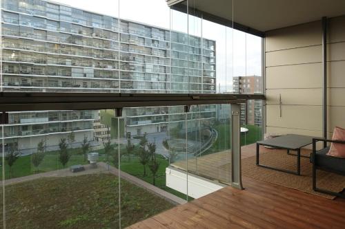 a room with a balcony with a large building at Modern 1BR with Huge Balcony Above Mall of Tripla in Helsinki