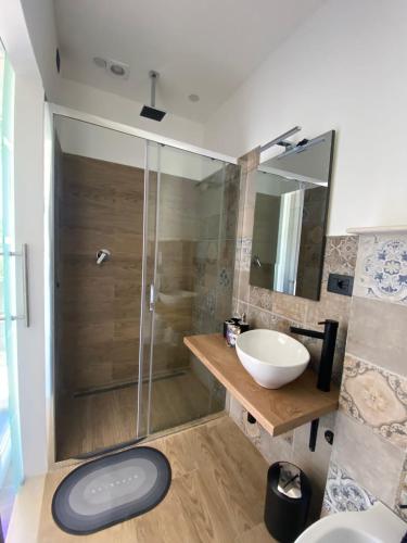 a bathroom with a sink and a shower at La Fenice 40 in Numana