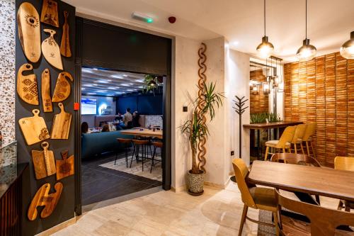 a room with a table and a dining room at Boutique Macchiato Rooms in Novi Sad