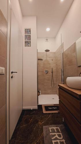 a bathroom with a shower and a sink and a tub at Casa Rodolfi, Vicenza in Vicenza