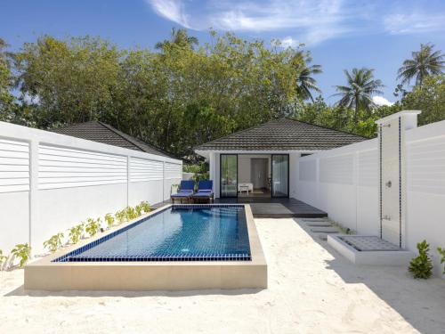 a swimming pool in the backyard of a house at Villa Nautica Paradise Island Resort in North Male Atoll