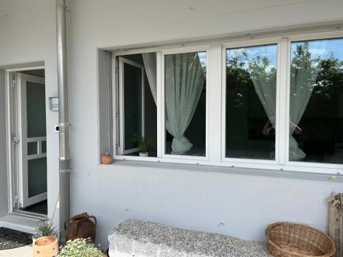 two windows on the side of a house at Studio in neuem EFH (2023) in Elsau