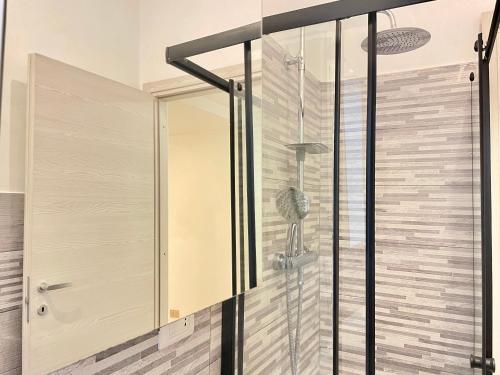 a glass shower door in a bathroom at GRAMSCI HOUSE - Anzio Centro in Anzio