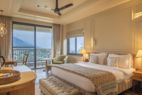 a bedroom with a large bed and a large window at Echor Mandara TreeVilla Dharamshala in Dharamshala