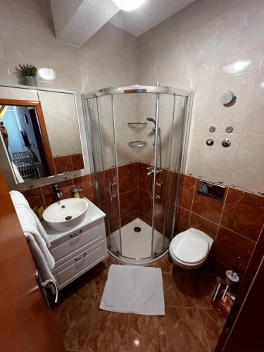 a bathroom with a shower and a toilet and a sink at Villa Marina Bol in Bol