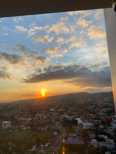 a view of a city with the sunset in the sky at Twilight23 Condo in Cebu City