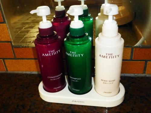 a group of four shampoo bottles sitting on a shelf at Kawaguchiko Lakeside Hotel in Fujikawaguchiko