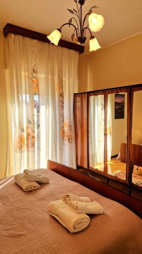 two towels are sitting on a bed in a bedroom at La perla sul Tirreno in Briatico