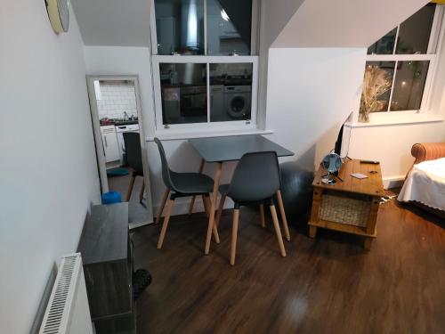 a living room with a table and two chairs at Cosy flat in central Wellington in Telford