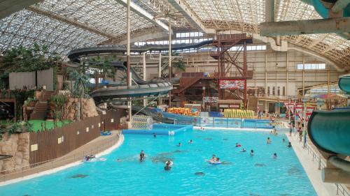 a large indoor swimming pool with people in it at Taira View Hotel in Iwaki
