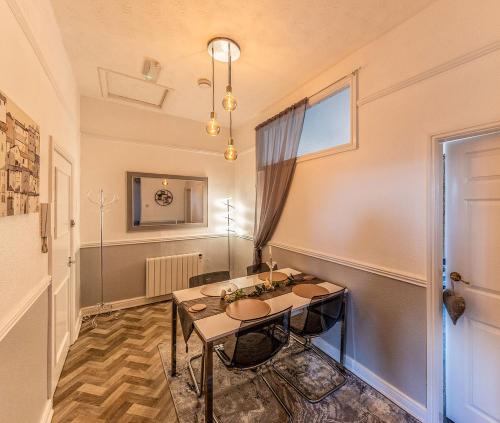 a dining room with a table and a window at Courtyard Holiday Apartments in Belper
