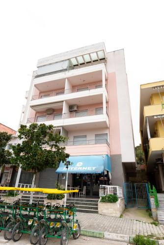 a building with green bikes parked in front of it at Penthouse Vista Mare in Orikum