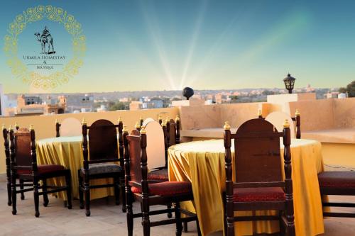 a set of tables and chairs with a view at Urmila Homestay And Boutique in Jaisalmer