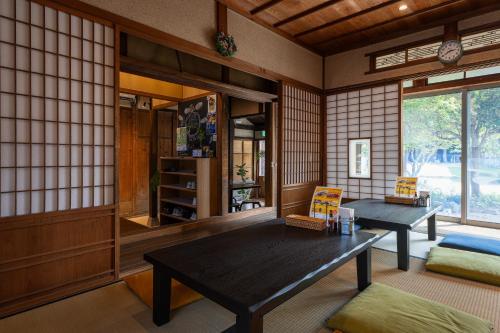 a room with two tables in a room with tiled walls at 法勝寺温泉 別館 
