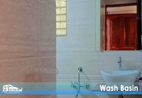 un baño con lavabo y espejo en Sea dreamz villa BY 29 BUNGALOW, en Alībāg