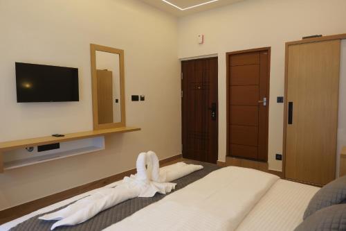 a bedroom with a bed with white towels on it at Bougainvillea Homestay Munnar in Munnar