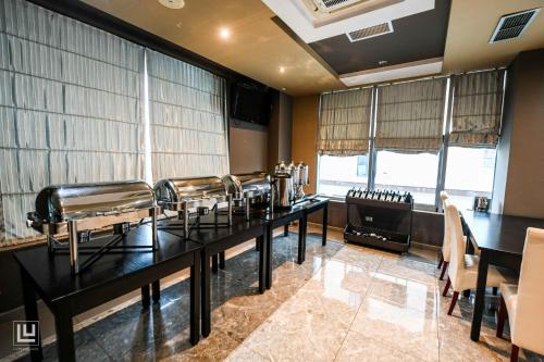 a dining room with a long table with chairs at Hotel Arifi in Shkodër