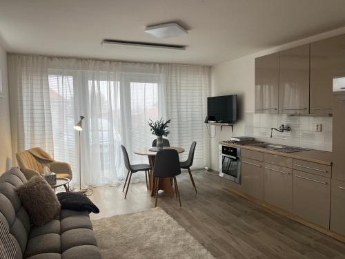 a kitchen and living room with a couch and a table at Apartmán Mašovice u Znojma in Mašovice