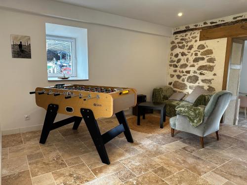 a living room with a foosball table in the corner at Gite à la ferme, élevage d'alpagas, Machupicchu in Champniers-et-Reilhac