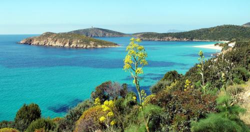 a view of the ocean from a hill at dépendance President villa Tuerredda in Chia