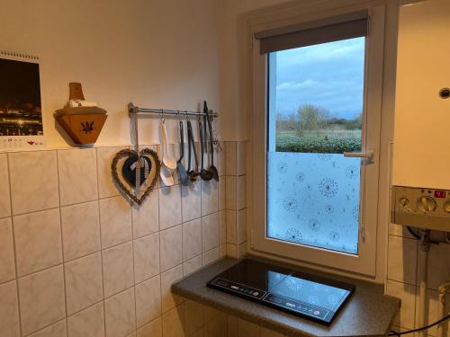 a kitchen with a window and a tablet on a counter at Ostseemöwe in Warnemünde