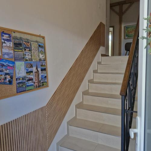 a staircase in a house with a picture on the wall at Žiar Apartmány 43 in Žiar
